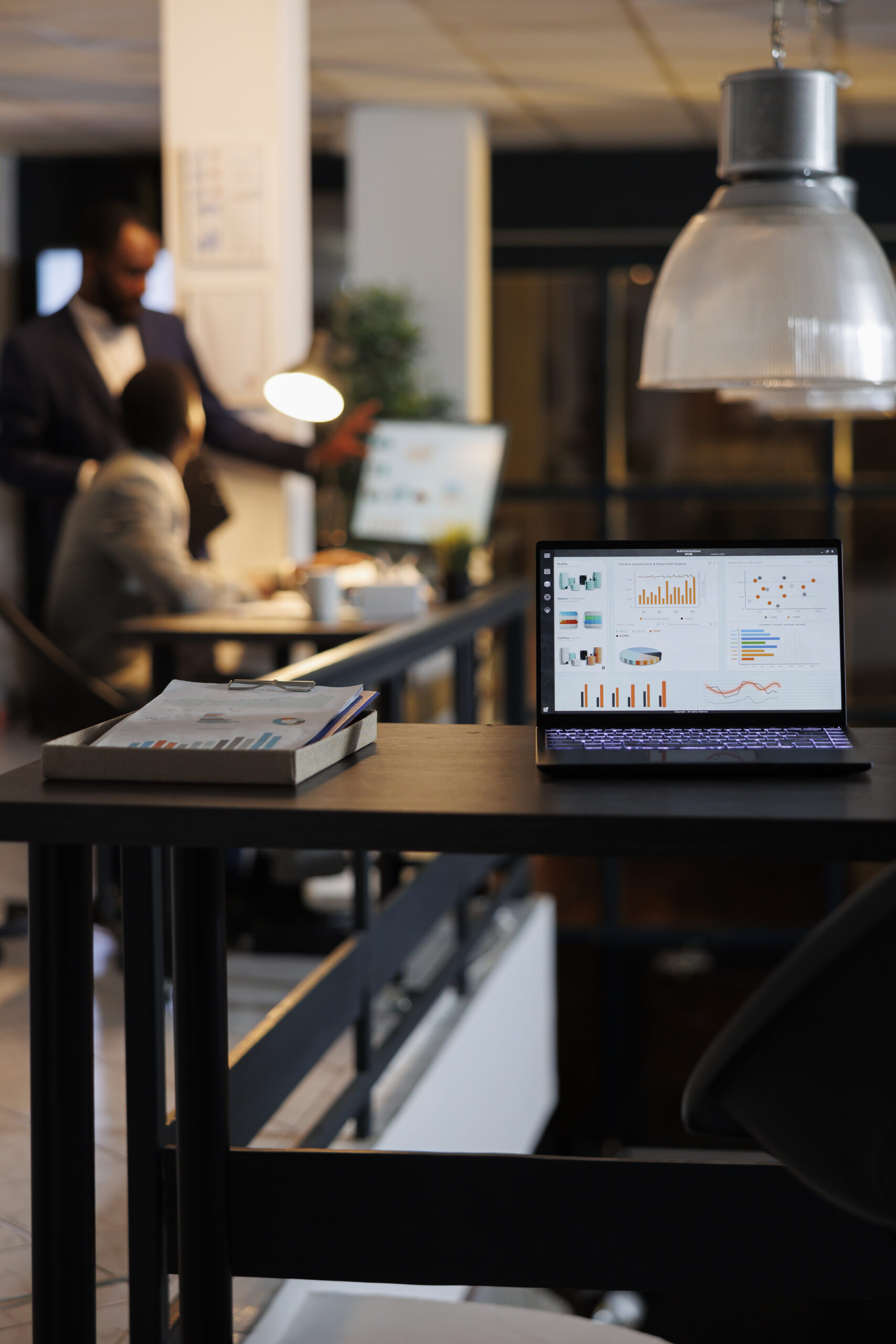 Laptop computer with financial graphs on screen