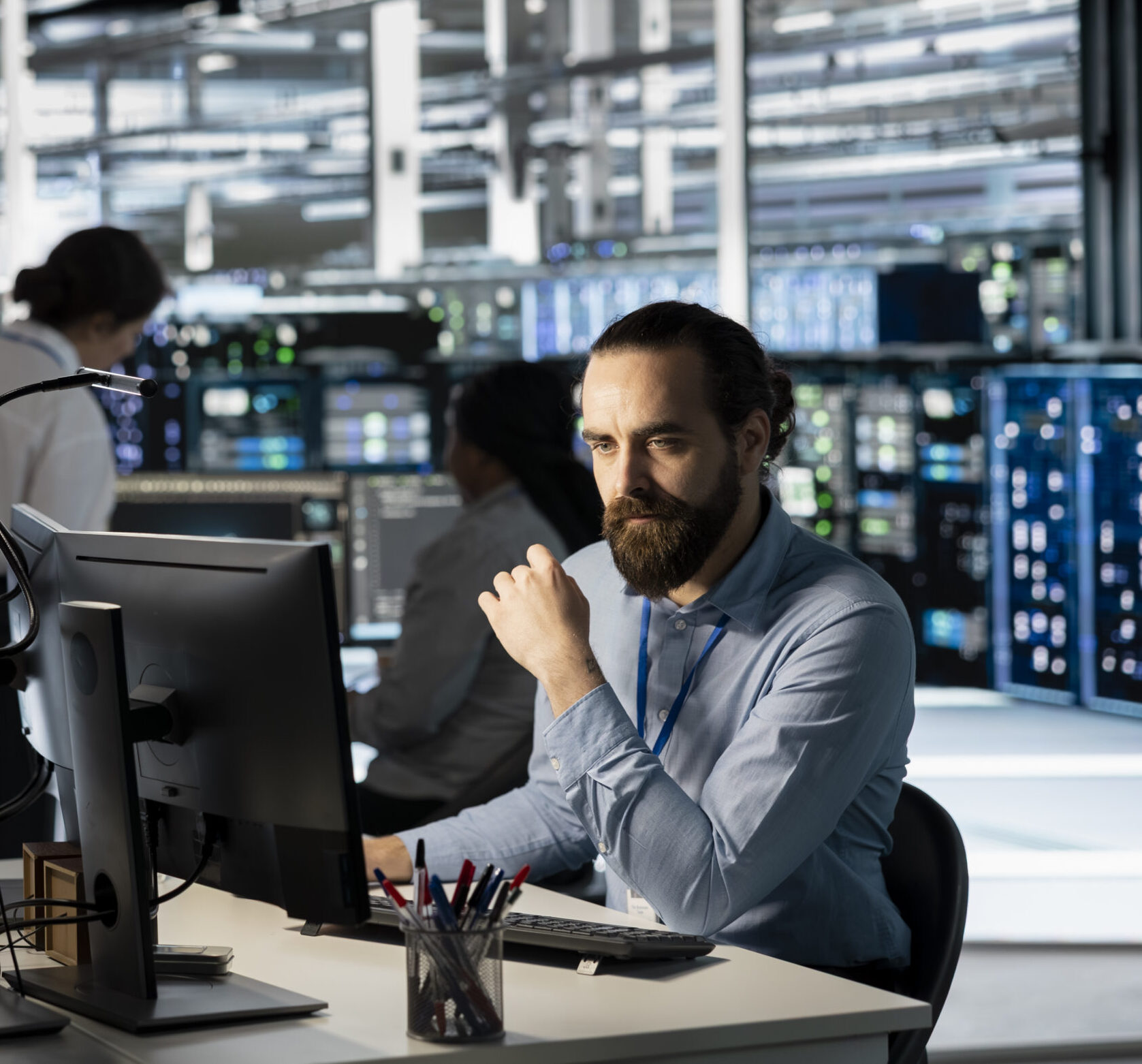 Technician using PC in data center to update server tech, configuring equipment